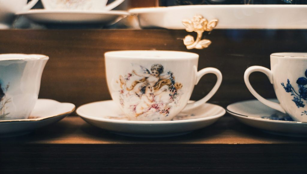 Collection of antique teacups with ornate designs.